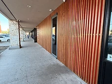 Storefront exterior, wood and red slat siding