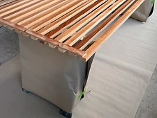 Wood slat bench, staged for install