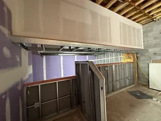 Kitchen framing — metal studs, gypsum board, and MEP rough-ins.
