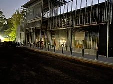 Two-story steel frame shell, dusk