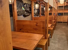 Dining area millwork — wood slat panels, partitions, and pendant lighting.