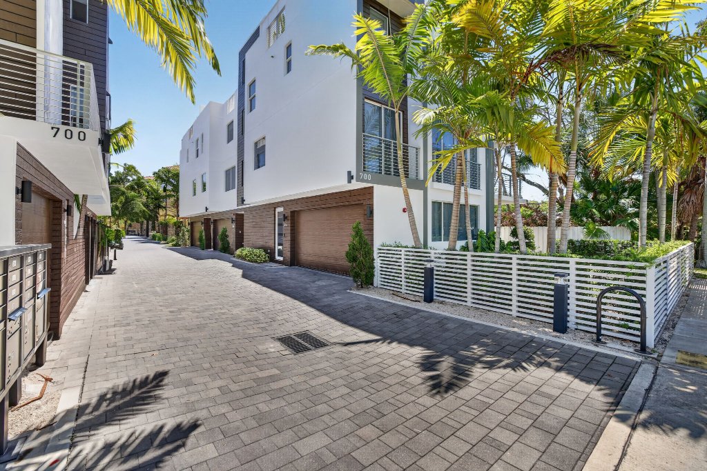 Modern four-story townhome in Victoria Park, Fort Lauderdale with floor-to-ceiling impact windows and protected greenway views