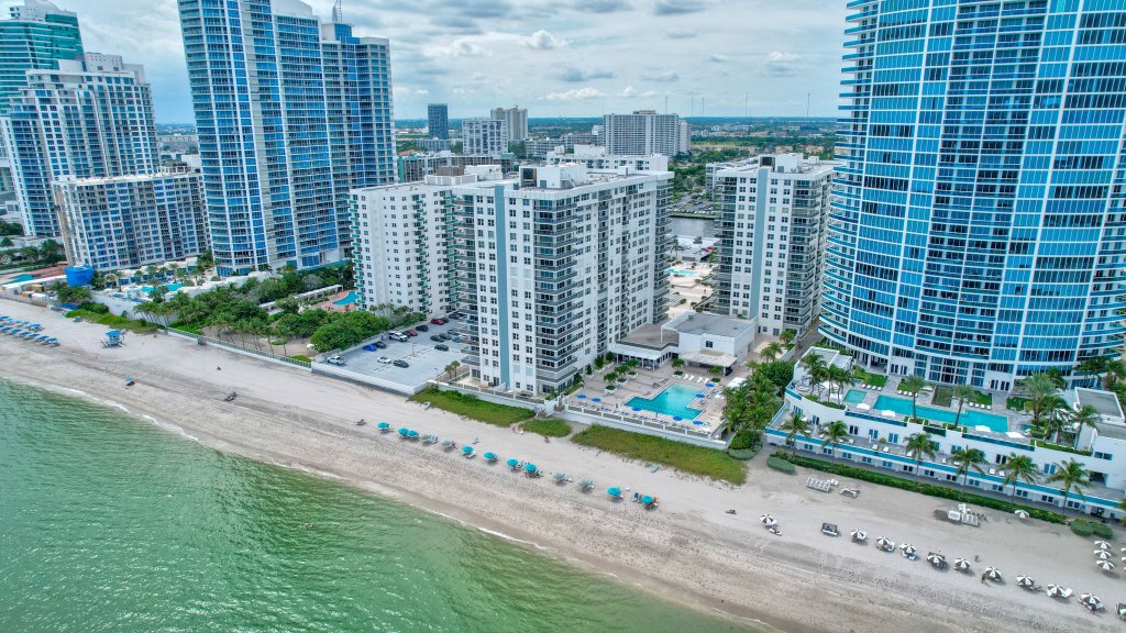 Oceanfront condo building in Hollywood Beach, FL with blue ocean views and modern architecture