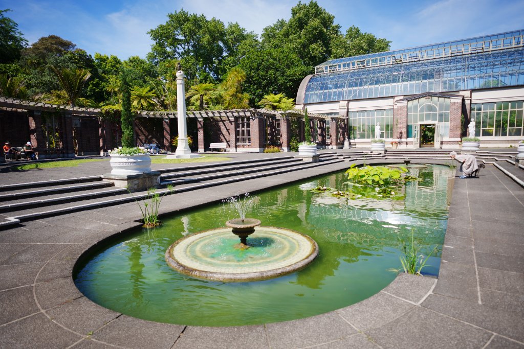 The reflection pond and Victorian glasshouse at the Auckland Domain Wintergardens.