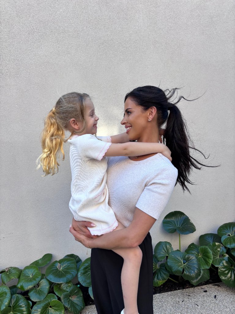 Melissa, founder of Nanny Concierge, embracing a child