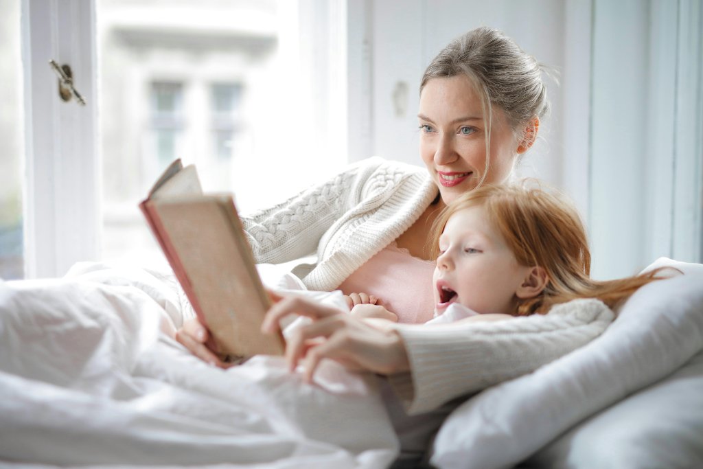 A nanny reading a bedtime story to a child