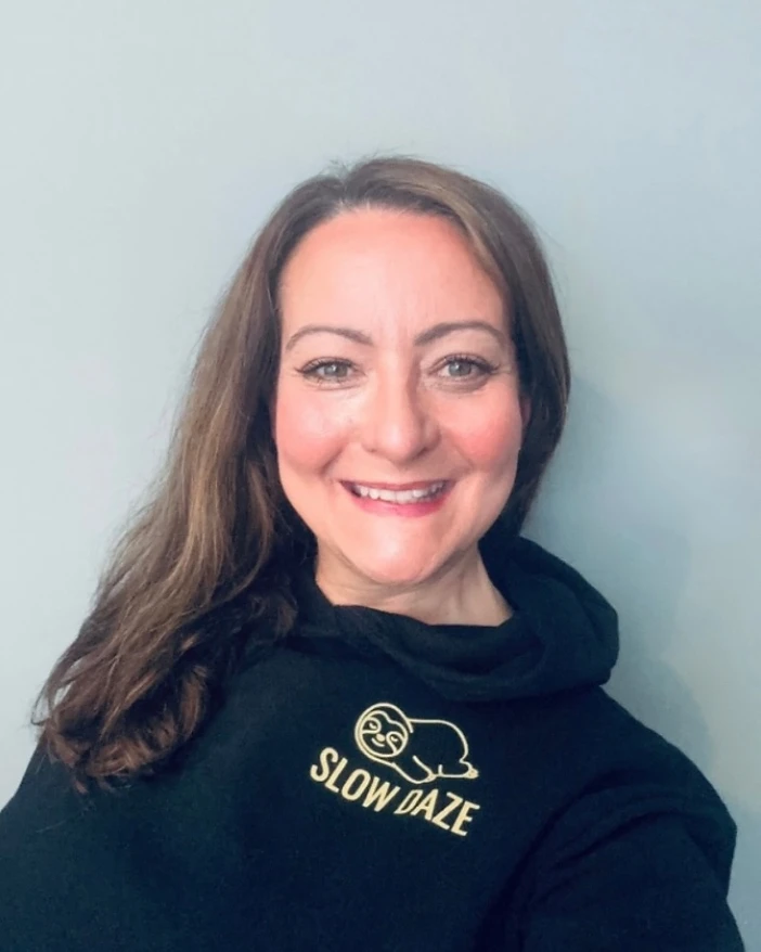 The founder of Slow Daze, wearing a black hoodie embroidered with the SLOW DAZE sloth logo