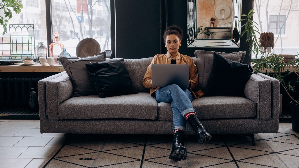 Woman working on a laptop in a modern lounge setting