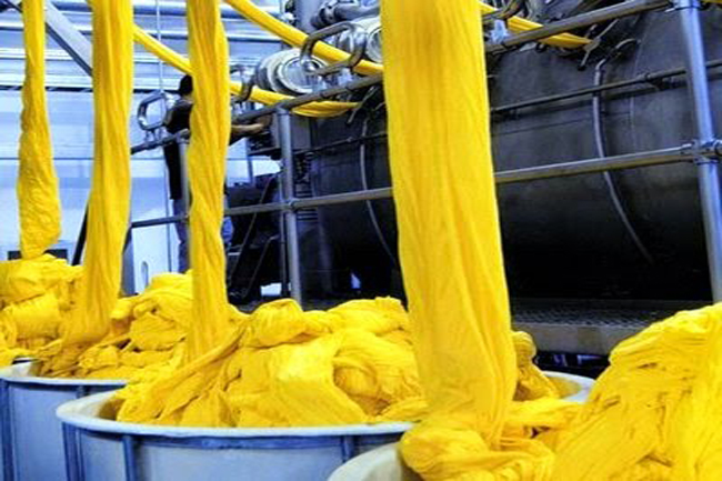 Dyeing & Finishing Unit — dyed fabric strips running through the industrial dyeing line