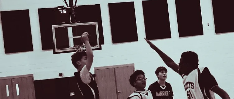 MACS basketball player shooting a jump shot