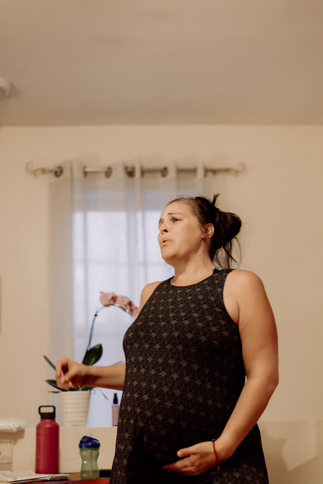 Woman in early labor standing at home