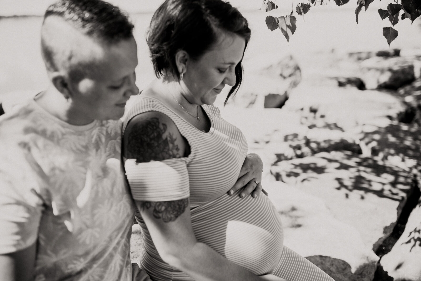 Black and white photo of pregnant woman and partner outdoors