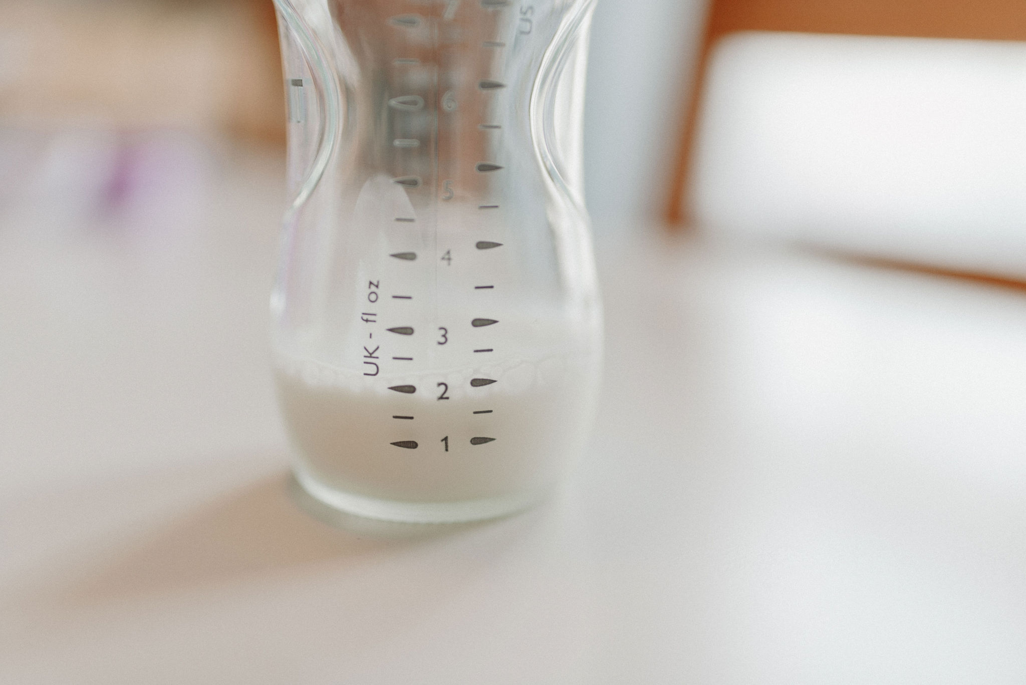 Close-up of a baby bottle showing the small volume a newborn takes in early feeds
