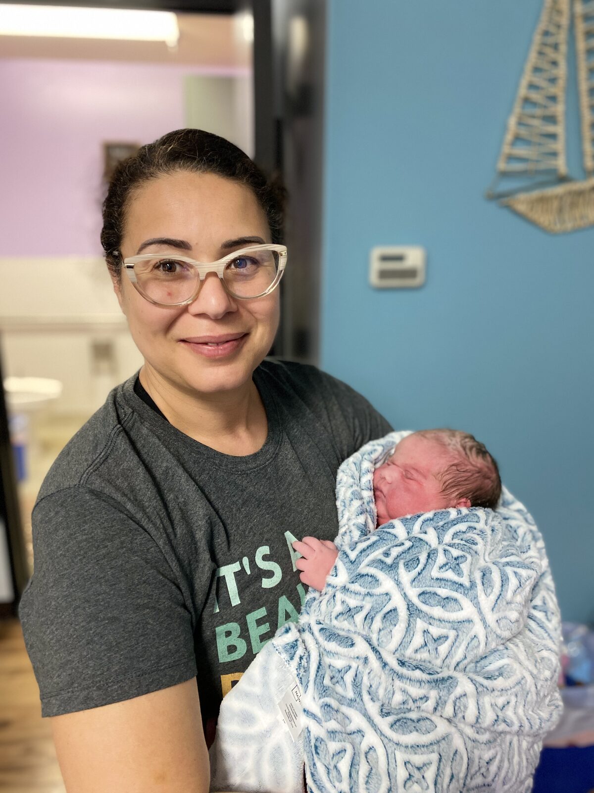 Midwife holding newborn baby shortly after birth