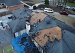 Deck exposed and inspected — damaged sheathing patched before the new shingles go down.