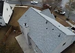 Aerial view of the finished roof from the rear — clean, uniform shingle lines across the home.