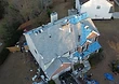 Mid-install — new shingles going down while remaining roof sections stay protected with underlayment.