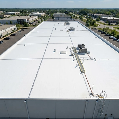 Finished roof — heat-welded 60-mil white TPO membrane with new edge metal and penetration flashing.