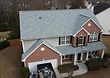 Completed roof — charcoal architectural shingles installed across all roof planes with clean ridges and flashing.