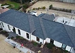 Completed upgrade — new charcoal architectural shingles installed in place of the old 3-tab roof.
