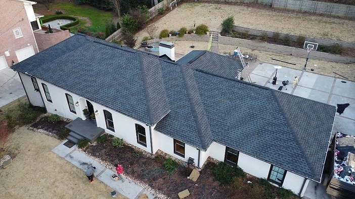 Completed upgrade — new charcoal architectural shingles installed in place of the old 3-tab roof.