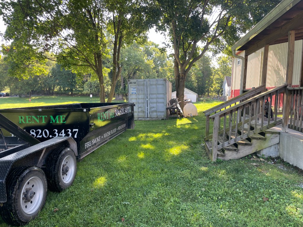 ZK dump trailer with RENT ME sign parked in residential yard
