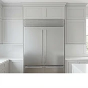 Vented stainless steel cover installed in the space above a refrigerator