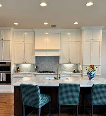 Chef's kitchen with marble island and houndstooth bar stools