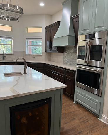 Transitional kitchen with sage green island and wine cooler
