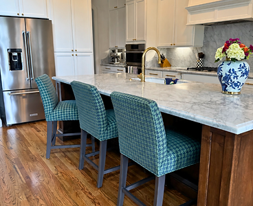 Custom kitchen island with houndstooth bar stools and marble counters