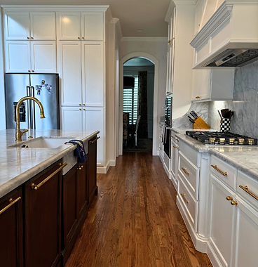 Two-tone kitchen with dark wood island and white perimeter cabinetry