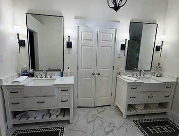 His and hers double vanity bathroom with marble floors