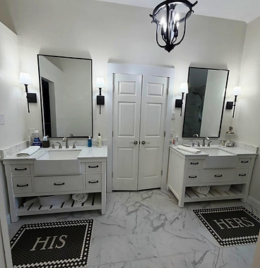 His and hers double vanity bathroom with marble floors
