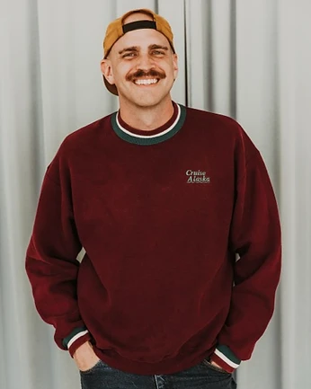 Scott Bedgood standing in maroon sweatshirt and trucker cap