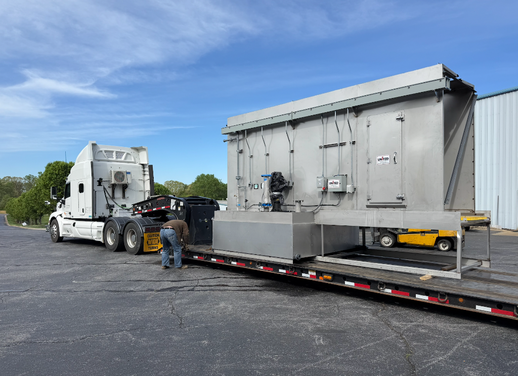 A complete United Finishing Systems unit being delivered by flatbed
