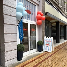 Sweet Tide storefront detail with OPEN sign and balloons