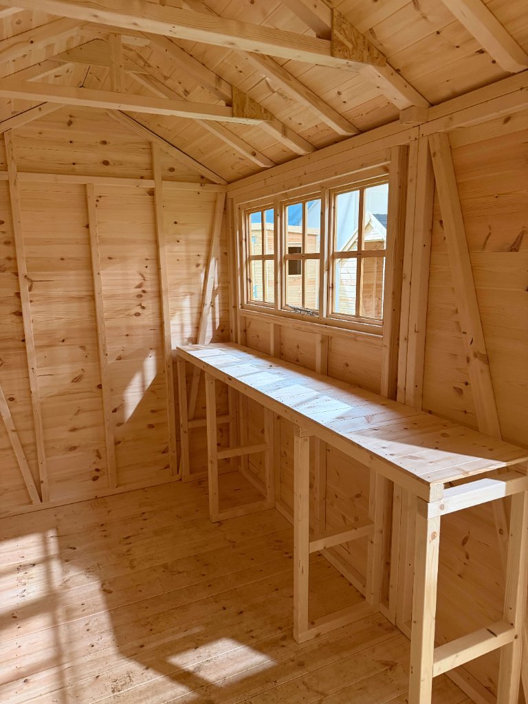 The Cumbria shed - interior with windows and workbench