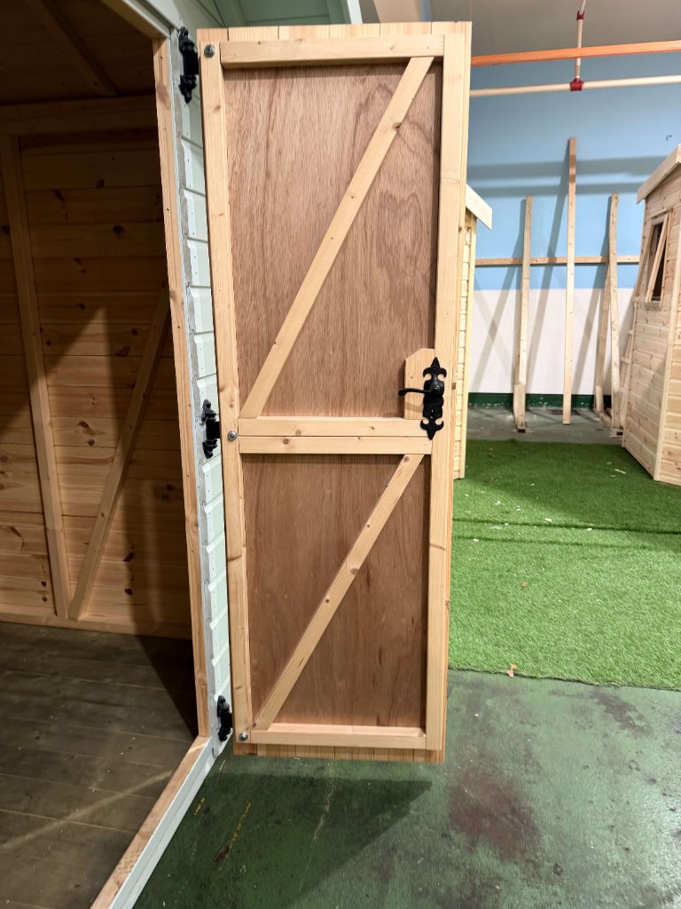 The Cumbria shed - open door with fleur-de-lis handle
