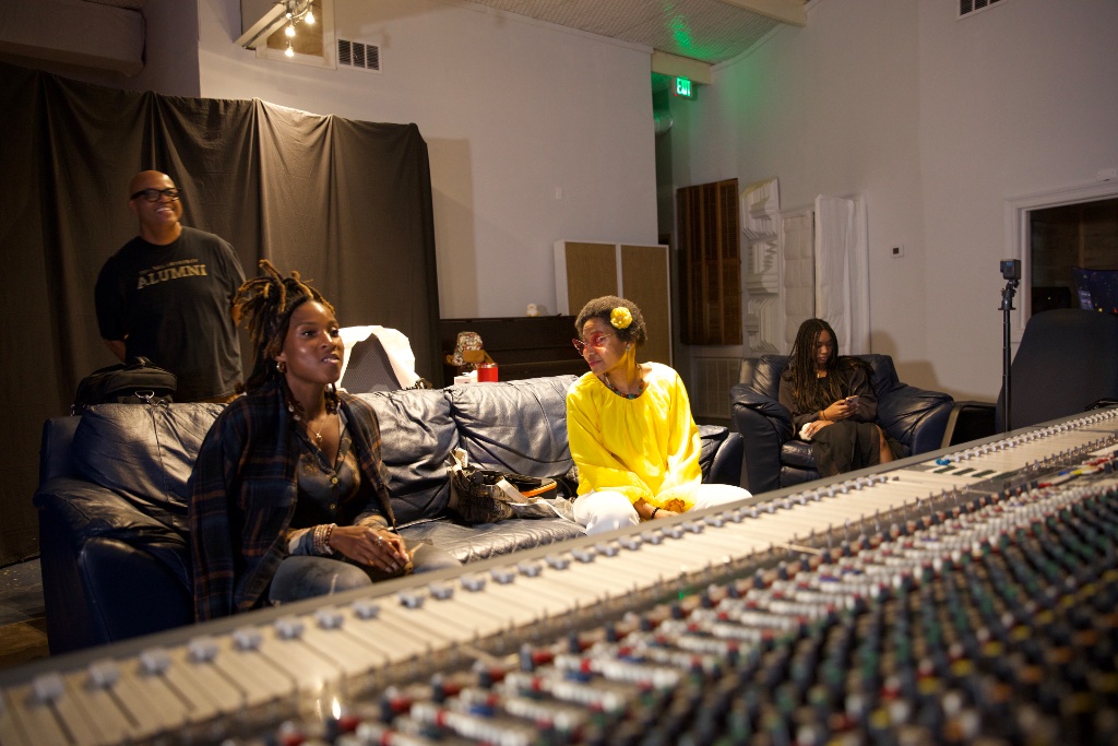 Dr. Jupiter in a yellow shirt during a studio session