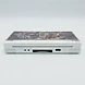 White Nintendo DS Lite console with a Transformers custom skin viewed from the rear charging port side
