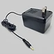Black power adapter for a Sega Genesis Slim console featuring a standard two-prong wall plug and a barrel connector tip