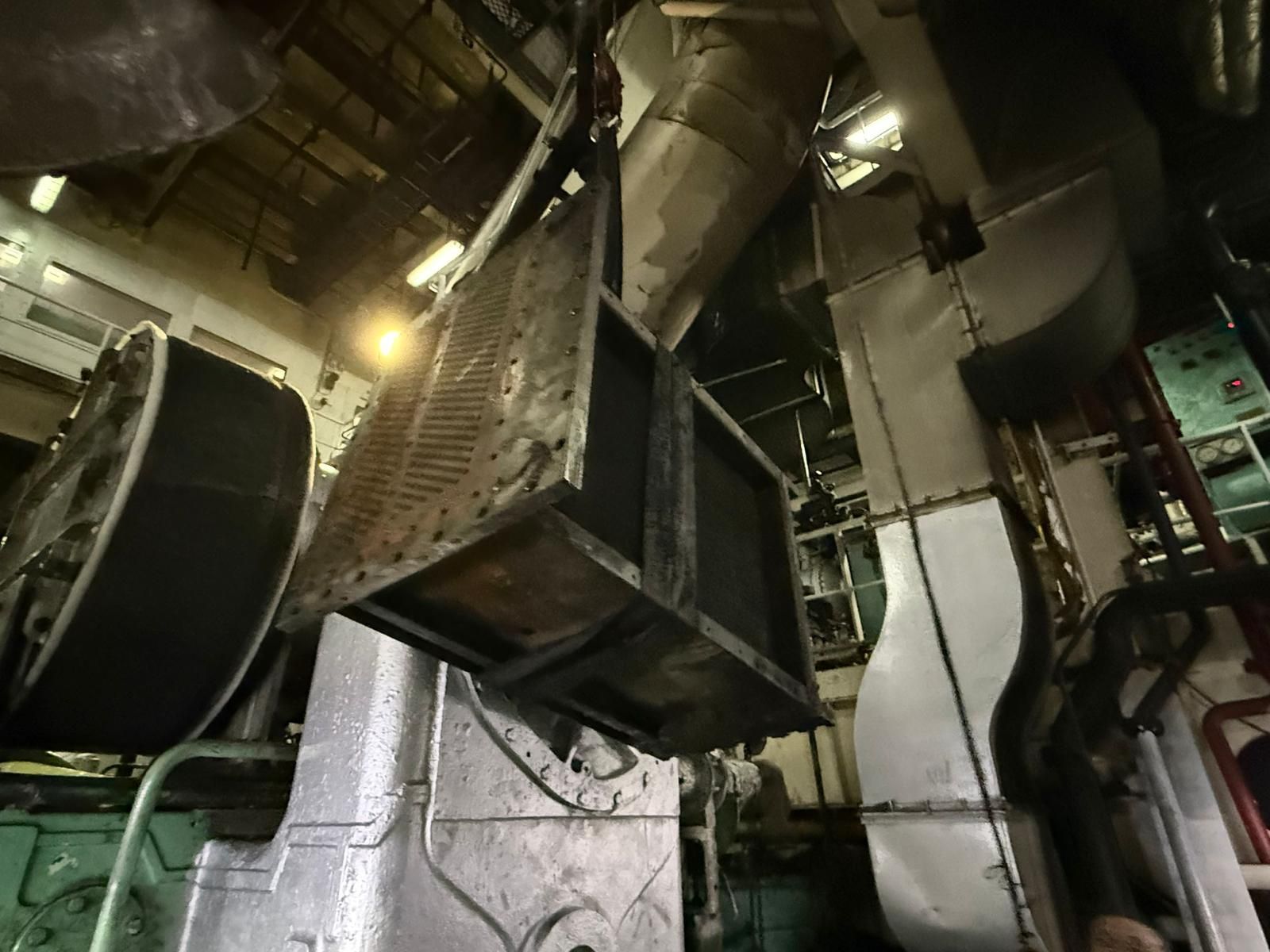 Air cooler unit suspended in the engine room during reinstallation