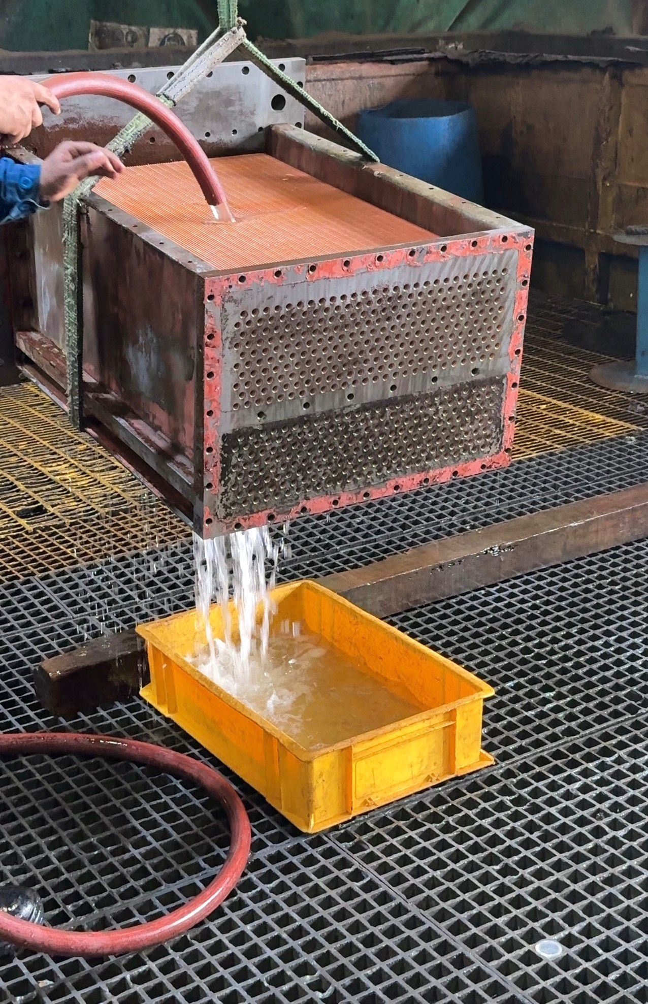 Air cooler tube stack being water flushed and checked during workshop servicing