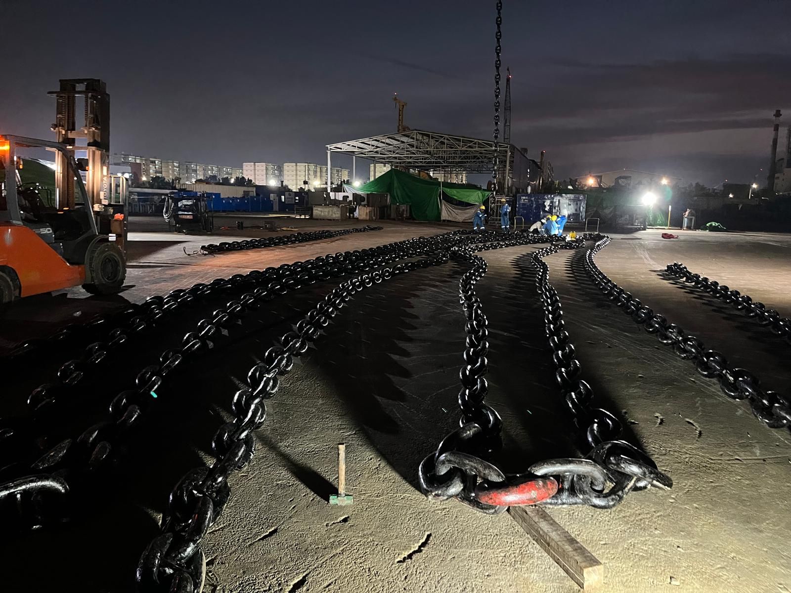 Anchor chain shots laid out ashore for inspection and preparation during night operations