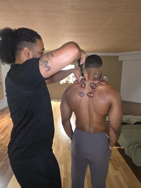 Courtney applying cupping therapy to a client