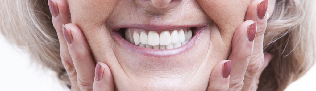Happy senior woman with dentures smiling at Mega Dental Richmond TX