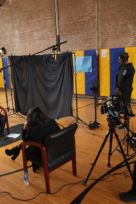 Shawn Brooks operating a cinema camera during a documentary interview production in Chicago