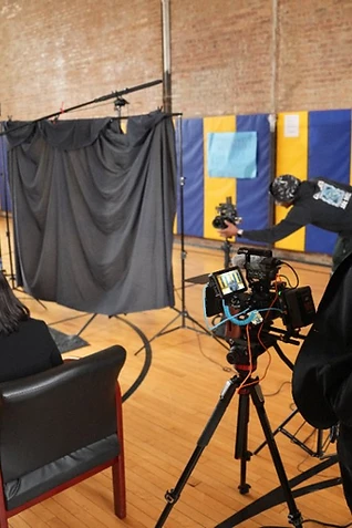 Shawn Brooks observing an interview during a documentary production on set in Chicago