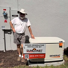 Happy Suncoast Power Solutions customer with their newly installed home generator yard sign