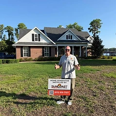 Happy Suncoast Power Solutions customer with their newly installed home generator yard sign